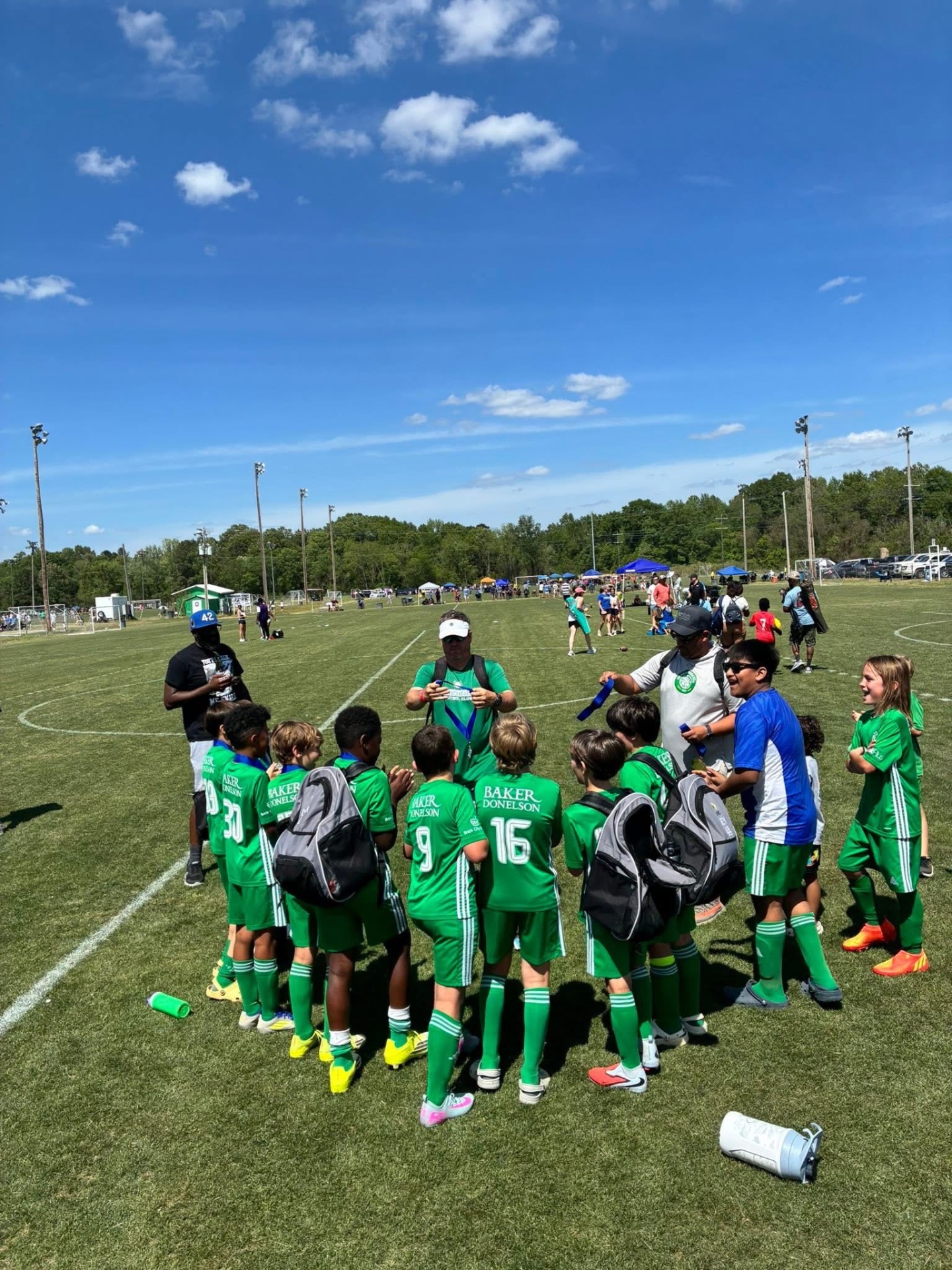 Team huddle receiving medals after the match