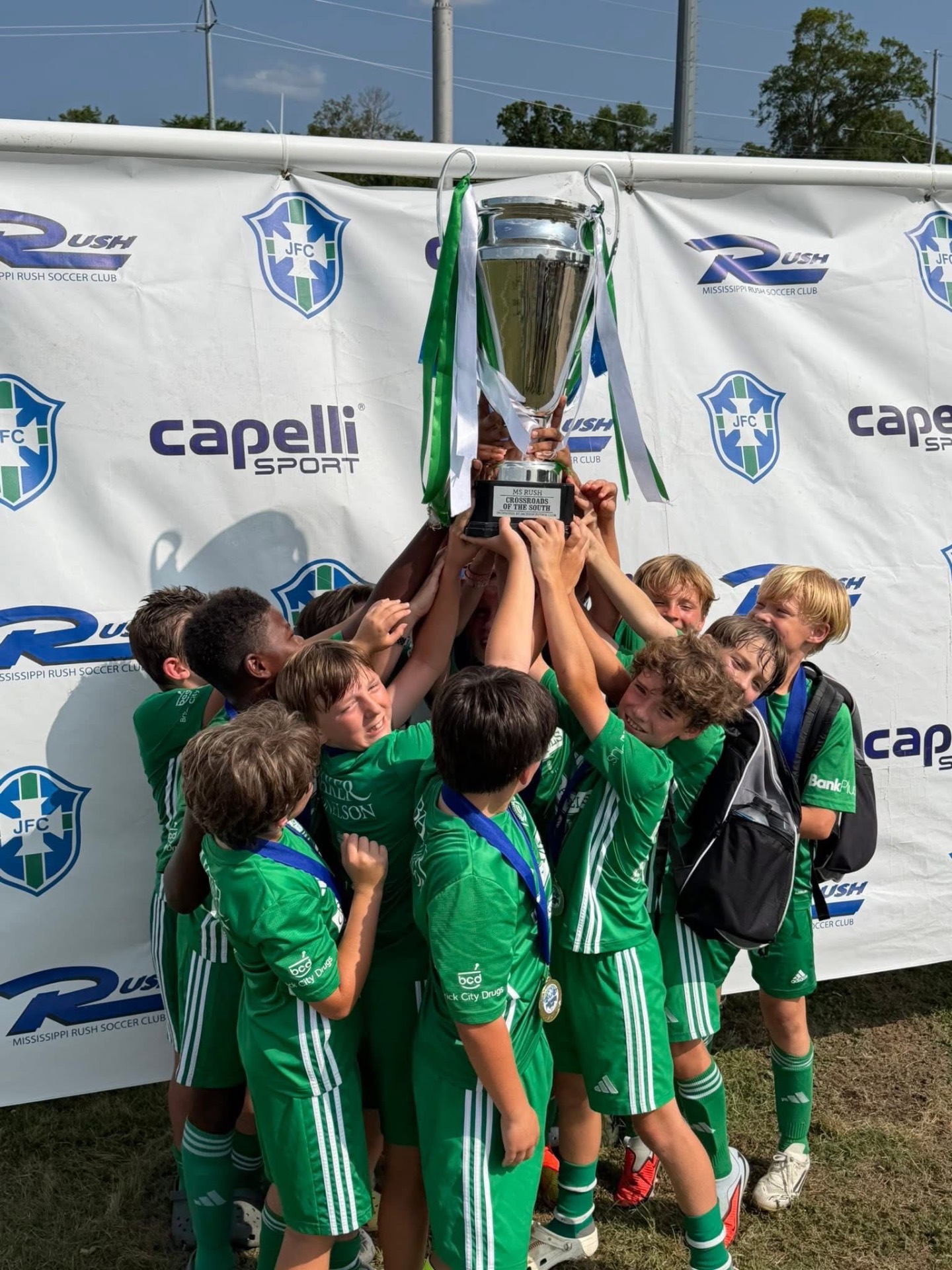 Boys team hoisting the Crossroads of the South cup