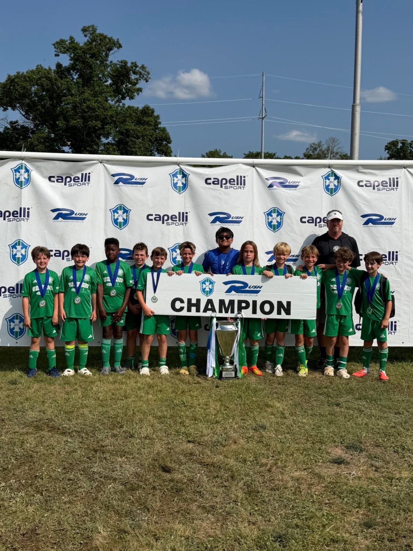 Champions with trophy and CHAMPION banner